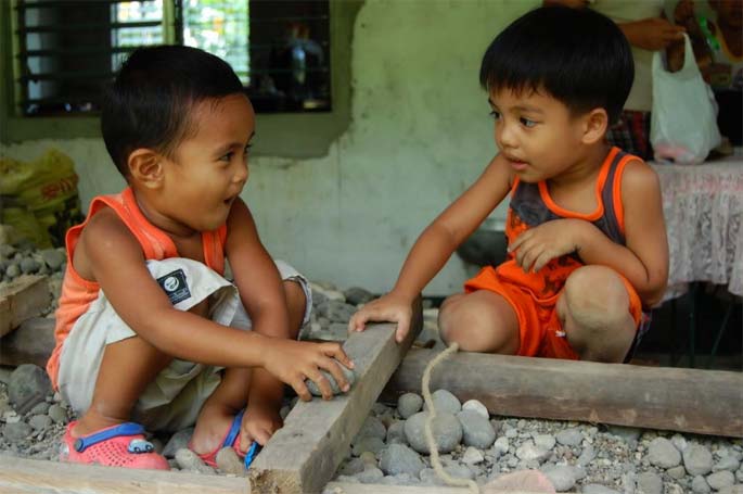 Two children playing in the Philippines