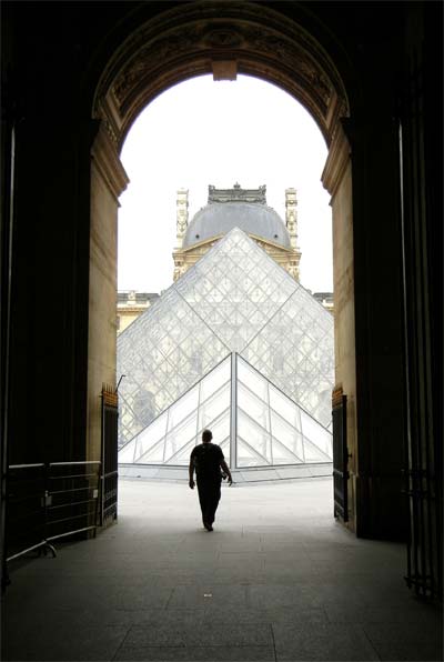 A silhouette in front of the Louvre