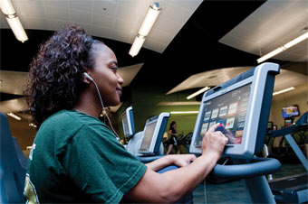 Bratisha Smith uses a touchscreen interface on one of the exercise machines.
