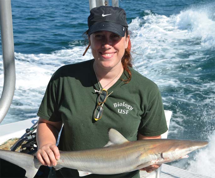 A USF student holds a shark.