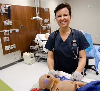 Dr. Laura Haubner with a mannequin in the Virtual Patient Care Center.