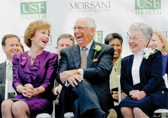 President Judy Genshaft, Frank Morsani and Carol Morsani sitting on stage at the announcement of the Morsani's philanthropic gift.