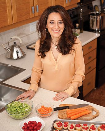 Patrizia La Trecchia in her kitchen with food on the counter.